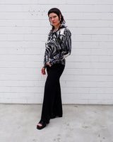 This black and white shirt doesn’t ask for attention — it just gets it. The abstract swirl pattern gives effortless chaos in the best way possible. Throw it on and let the print do the talking!