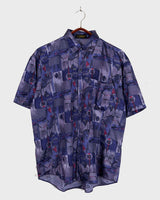 Bold, breezy, and silky smooth - this rare 90s short-sleeve gem by T. Corner is made from real Thai silk, brought to you by one of Thailand’s most renowned silk producers. The glossy fabric pops with a crazy pattern in electric purples and blues that’s impossible to ignore. Wear it loud, wear it proud!