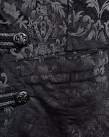This Y2k black vest blends classic baroque style with a subtle gothic edge. The textured floral pattern and fleur-de-lis buttons give it a refined yet bold character. Cool, confident and a little unexpected – a standout piece without shouting.
