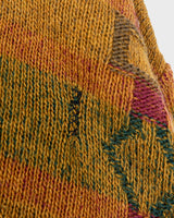 This vintage sweater has fall vibes written all over it, thanks to its alpaca and lambs wool mix in a cozy brown, mustard-yellow combo!