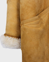Cozy up in this vintage 80s shearling coat, perfect for chilly days. Its rich brown and mustard yellow colors add a bold touch, while the shearling material provides warmth and comfort. A must-have piece for your wardrobe, this coat is a timeless addition that will never go out of style.