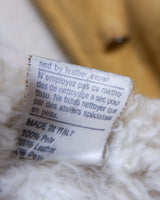Cozy up in this vintage 80s shearling coat, perfect for chilly days. Its rich brown and mustard yellow colors add a bold touch, while the shearling material provides warmth and comfort. A must-have piece for your wardrobe, this coat is a timeless addition that will never go out of style.