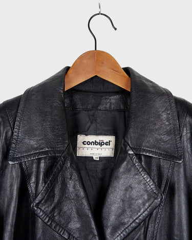 This vintage 90s black long leather belted (optional belt!) coat is your ticket to a timeless look!