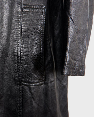 This vintage 90s black long leather belted (optional belt!) coat is your ticket to a timeless look!