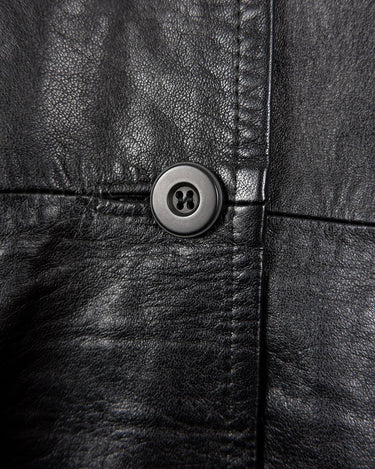 This vintage 90s black long leather belted (optional belt!) coat is your ticket to a timeless look!