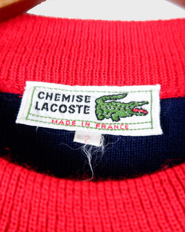 Look snazzy in this navy blue and red color mix Lacoste sweater! This longer fit (length: 66cm) is perfect for keeping you warm and looking snazzy.