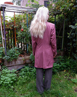 This vintage blazer in a striking dark pink is a must-have for any fashion-forward individual. Its long fit and two rows of buttons add a unique twist to any outfit. Whether you're dressing up for a formal event or adding some flair to your everyday look, this blazer has got you covered. (No time for boring fashion here!)