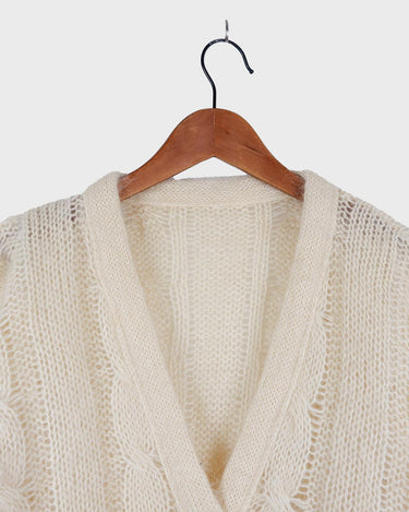 Slip into this cozy Premium Vintage 90s mohair superkid mix cable knit cardigan! Soft, furry and light transparent with a unique twist on a classic style, this cardigan is a must-have for any cable knit lovers!