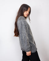 Get your hands on this amazing Vintage 80s grey mohair mix cardigan! It comes with fun pink buttons that add a touch of playfulness to your outfit. Perfect for layering and adding a pop of color to your look.