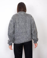 Get your hands on this amazing Vintage 80s grey mohair mix cardigan! It comes with fun pink buttons that add a touch of playfulness to your outfit. Perfect for layering and adding a pop of color to your look.