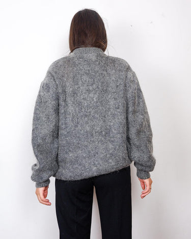 Get your hands on this amazing Vintage 80s grey mohair mix cardigan! It comes with fun pink buttons that add a touch of playfulness to your outfit. Perfect for layering and adding a pop of color to your look.