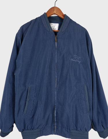 Channel your inner '90s cool kid in this stylish blue bomber jacket! Featuring a stitched logo and classic design, it'll give you the amazing look you crave!