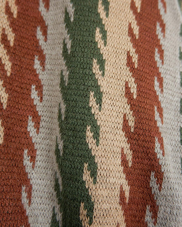 This vintage, 70s-inspired vest (thin) is a classic look you'll love! The earthy green and brown tones create an effortlessly cool look. Button up and feel the 70s vibes!