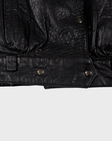 This Vintage 80s black leather jacket is the ultimate classic, complete with press buttons, structured vibes, and smooth leather.