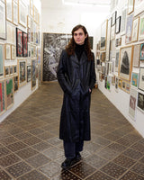 This vintage 90s black long leather belted (optional belt!) coat is your ticket to a timeless look!