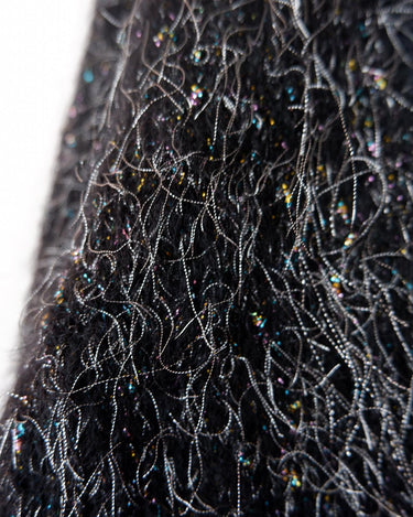 Add some retro sparkle to your wardrobe with this vintage 80s black glitter v-neck sweater. Who needs subtle when you can shine?!