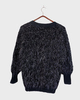 Add some retro sparkle to your wardrobe with this vintage 80s black glitter v-neck sweater. Who needs subtle when you can shine?!