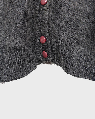 Get your hands on this amazing Vintage 80s grey mohair mix cardigan! It comes with fun pink buttons that add a touch of playfulness to your outfit. Perfect for layering and adding a pop of color to your look.
