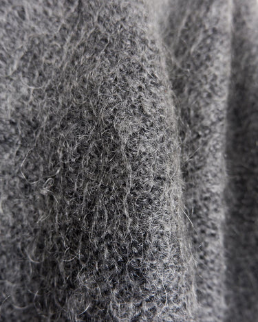 Get your hands on this amazing Vintage 80s grey mohair mix cardigan! It comes with fun pink buttons that add a touch of playfulness to your outfit. Perfect for layering and adding a pop of color to your look.