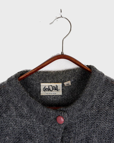Get your hands on this amazing Vintage 80s grey mohair mix cardigan! It comes with fun pink buttons that add a touch of playfulness to your outfit. Perfect for layering and adding a pop of color to your look.