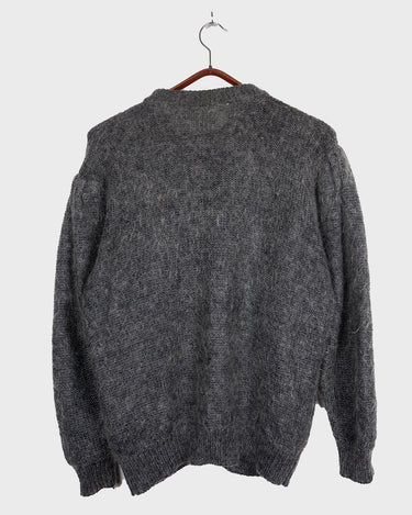 Get your hands on this amazing Vintage 80s grey mohair mix cardigan! It comes with fun pink buttons that add a touch of playfulness to your outfit. Perfect for layering and adding a pop of color to your look.