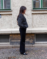 Add some retro sparkle to your wardrobe with this vintage 80s black glitter v-neck sweater. Who needs subtle when you can shine?!