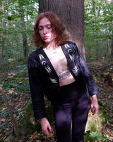 Unleash your inner rebel with this vintage 80s black leather crop fringe jacket. Made from high-quality leather, this XS jacket features fringe detailing that will make a statement. 