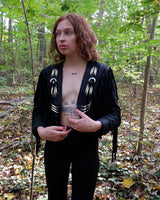 Unleash your inner rebel with this vintage 80s black leather crop fringe jacket. Made from high-quality leather, this XS jacket features fringe detailing that will make a statement. 