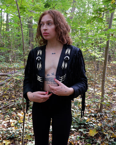Unleash your inner rebel with this vintage 80s black leather crop fringe jacket. Made from high-quality leather, this XS jacket features fringe detailing that will make a statement. 