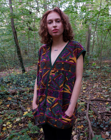 Wrap yourself in quirky, vintage charm with our colorful 80s fleece vest! Featuring a fun, pattern-filled design, this XL vest will keep you cozy in style. 