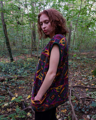 Wrap yourself in quirky, vintage charm with our colorful 80s fleece vest! Featuring a fun, pattern-filled design, this XL vest will keep you cozy in style. 