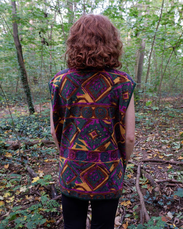 Wrap yourself in quirky, vintage charm with our colorful 80s fleece vest! Featuring a fun, pattern-filled design, this XL vest will keep you cozy in style. 