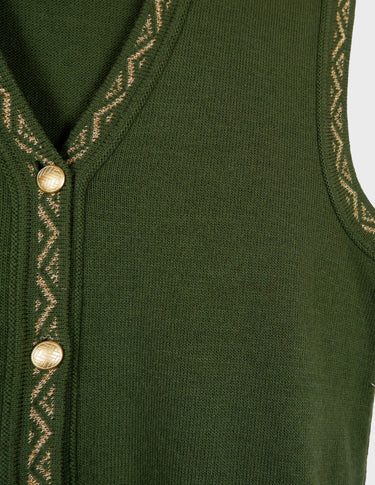 a woman is wearing a vintage 90s long green vest with golden details.