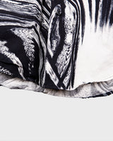 This black and white shirt doesn’t ask for attention — it just gets it. The abstract swirl pattern gives effortless chaos in the best way possible. Throw it on and let the print do the talking!