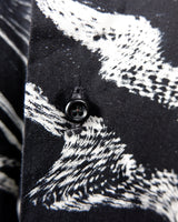 This black and white shirt doesn’t ask for attention — it just gets it. The abstract swirl pattern gives effortless chaos in the best way possible. Throw it on and let the print do the talking!