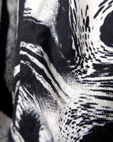 This black and white shirt doesn’t ask for attention — it just gets it. The abstract swirl pattern gives effortless chaos in the best way possible. Throw it on and let the print do the talking!