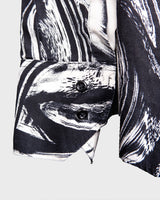 This black and white shirt doesn’t ask for attention — it just gets it. The abstract swirl pattern gives effortless chaos in the best way possible. Throw it on and let the print do the talking!