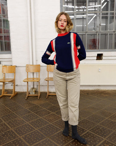 Look snazzy in this navy blue and red color mix Lacoste sweater! This longer fit (length: 66cm) is perfect for keeping you warm and looking snazzy.