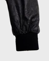 This vintage 90s black bomber jacket is a unisex must-have for any wardrobe! Made from heavy leather, this jacket boasts a timeless look with a touch of edge.