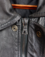 This vintage 90s black bomber jacket is a unisex must-have for any wardrobe! Made from heavy leather, this jacket boasts a timeless look with a touch of edge.