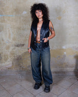 Embrace your inner rebel with this vintage 80s 90s black biker leather vest! Perfect for adding a touch of edge to any outfit, this vest is full of personality and attitude. Made with genuine leather, it offers both style and durability.