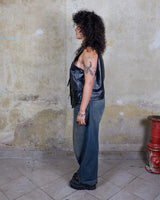 Embrace your inner rebel with this vintage 80s 90s black biker leather vest! Perfect for adding a touch of edge to any outfit, this vest is full of personality and attitude. Made with genuine leather, it offers both style and durability.