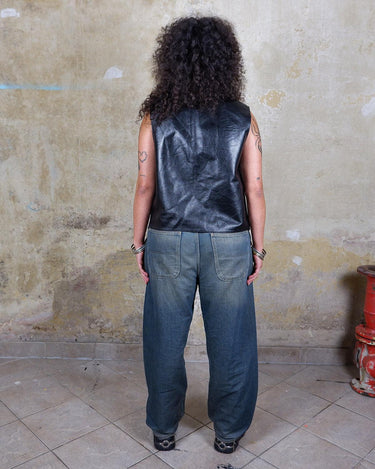 Embrace your inner rebel with this vintage 80s 90s black biker leather vest! Perfect for adding a touch of edge to any outfit, this vest is full of personality and attitude. Made with genuine leather, it offers both style and durability.