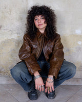 Fall in love with this italian vintage 80s brown leather jacket! With its classic look, warm wool lining, and thick leather material, you'll look and feel great while staying cozy!