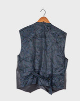 Rock your vintage style with our 90s grey leather vest! This unique piece features a playful paisley pattern at the back for a touch of fun.