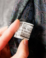 Rock your vintage style with our 90s grey leather vest! This unique piece features a playful paisley pattern at the back for a touch of fun.