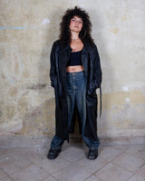 This vintage 80s coat features a fierce black animal print, adding a unique touch to any outfit. The belted waist cinches in for a flattering fit, making you feel confident and channeling your inner wild side.