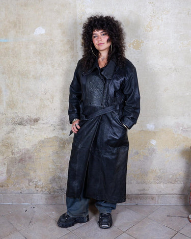 This vintage 80s coat features a fierce black animal print, adding a unique touch to any outfit. The belted waist cinches in for a flattering fit, making you feel confident and channeling your inner wild side.