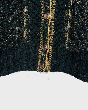 Add some sparkle to your wardrobe with this vintage 80s green cardigan, featuring eye-catching golden details. Perfect for layering and dressing up any outfit!