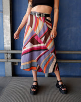 This Y2k skirt serves pure elegance with its flowing silhouette and vibrant geometric print in magenta, teal, orange, and warm brown. Light and easy to wear, it’s comfortable and anything but boring—designed for those who dress with intention.